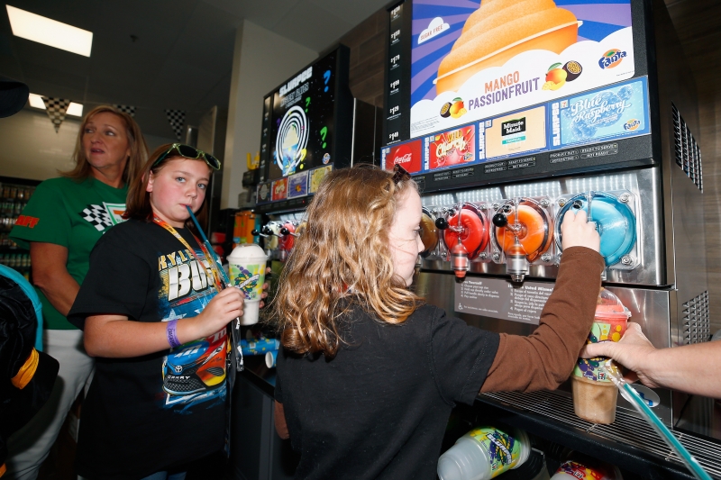 FORT WORTH, TX - NOVEMBER 02:  "Grand opening" festivities of 7-Eleven on property. General ambiance shots of fans on site, Kyle Busch autograph session, fans getting items signed, fans in M&Ms simulator or checking out show car, TMS President Eddie Gossage serving free Slurpees to fans during practice for the Monster Energy NASCAR Cup Series AAA Texas 500 at Texas Motor Speedway on November 2, 2018 in Fort Worth, Texas.  (Photo by Matt Sullivan/Getty Images)