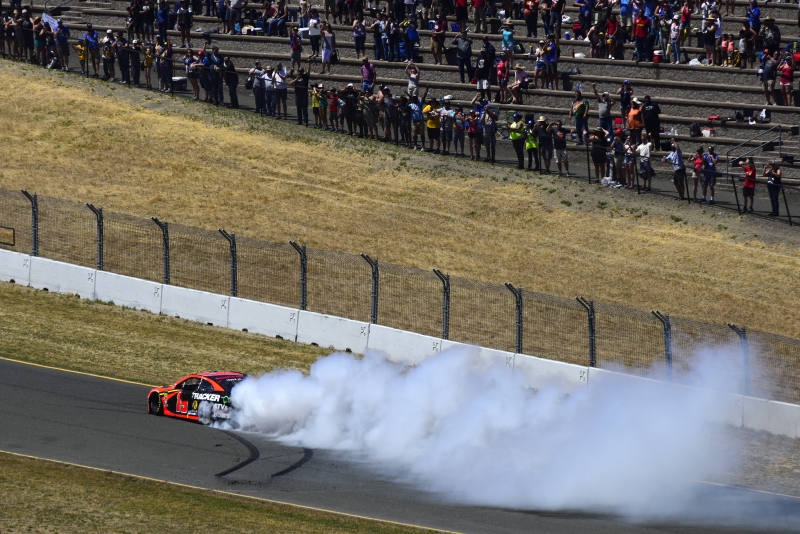 Martin Truex Jr., driver of the #19 Bass Pro Shops Toyota, celebrates with a burnout after winning the Monster Energy NASCAR Cup Series Toyota/Save Mart 350 at Sonoma Raceway on June 23, 2019 in Sonoma, California. (Photo by Jared C. Tilton/Getty Images)