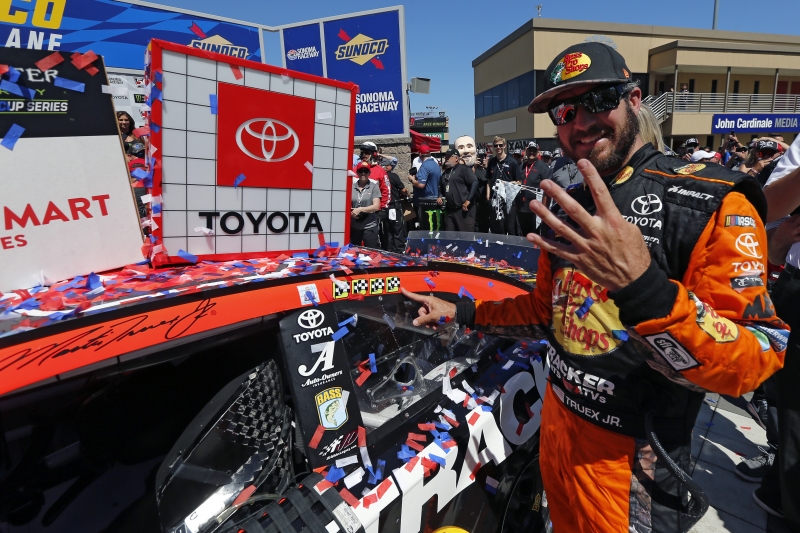 Martin Truex Jr., driver of the #19 Bass Pro Shops Toyota, poses with the winner’s decal on his car in Victory Lane after winning the Monster Energy NASCAR Cup Series Toyota/Save Mart 350 at Sonoma Raceway on June 23, 2019 in Sonoma, California. (Photo by Jonathan Ferrey/Getty Images)