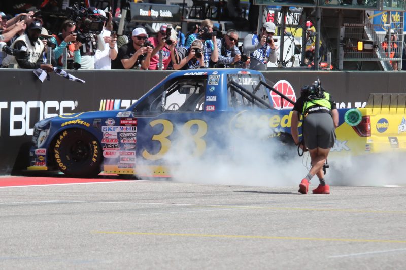 Mar 25, 2023; Austin, Texas, USA;  NASCAR Craftsman Truck Series driver Zane Smith (38) does a burn out after winning the XPEL 225 at the Circuit of the Americas. Credit: Michael C. Johnson