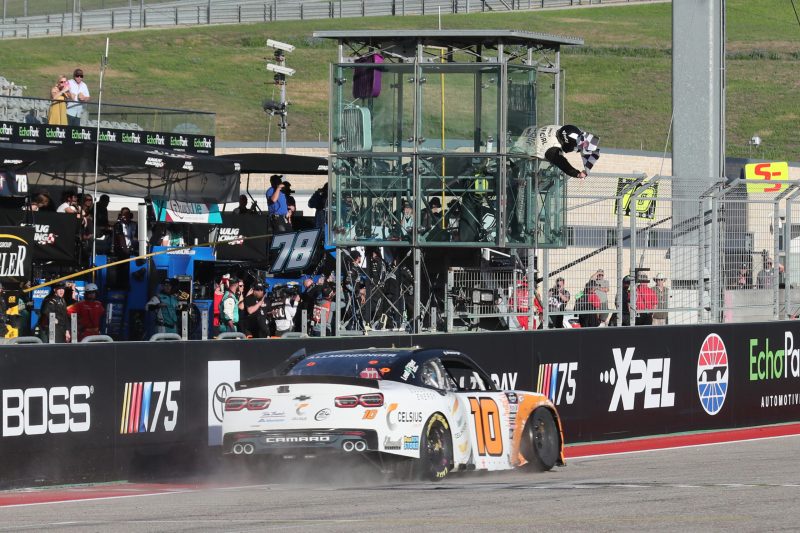 Mar 25, 2023; Austin, Texas, USA;  NASCAR Xfinity Series driver AJ Allmendinger (10) takes the checked flag during the Pit Boss 250 presented by USA Today at the Circuit of the Americas. Credit: Michael C. Johnson