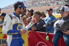 LAS VEGAS, NEVADA - MARCH 06: Chase Elliott, driver of the #9 NAPA Auto Parts Chevrolet, fist bumps a young fan prior to the NASCAR Cup Series Pennzoil 400 at Las Vegas Motor Speedway on March 06, 2022 in Las Vegas, Nevada. (Photo by Meg Oliphant/Getty Images)